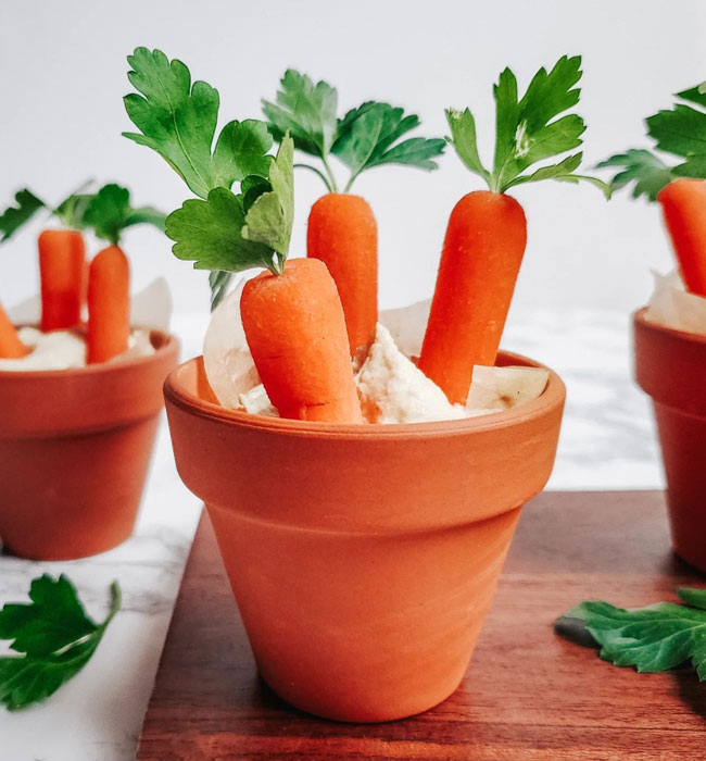 mini clay pots with hummus and carrots